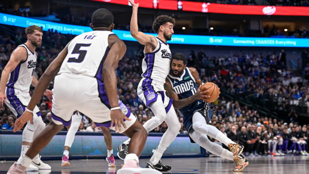 Dallas Mavericks star Kyrie Irving gets smothered by the Sacramento Kings' defense in Sunday's loss.